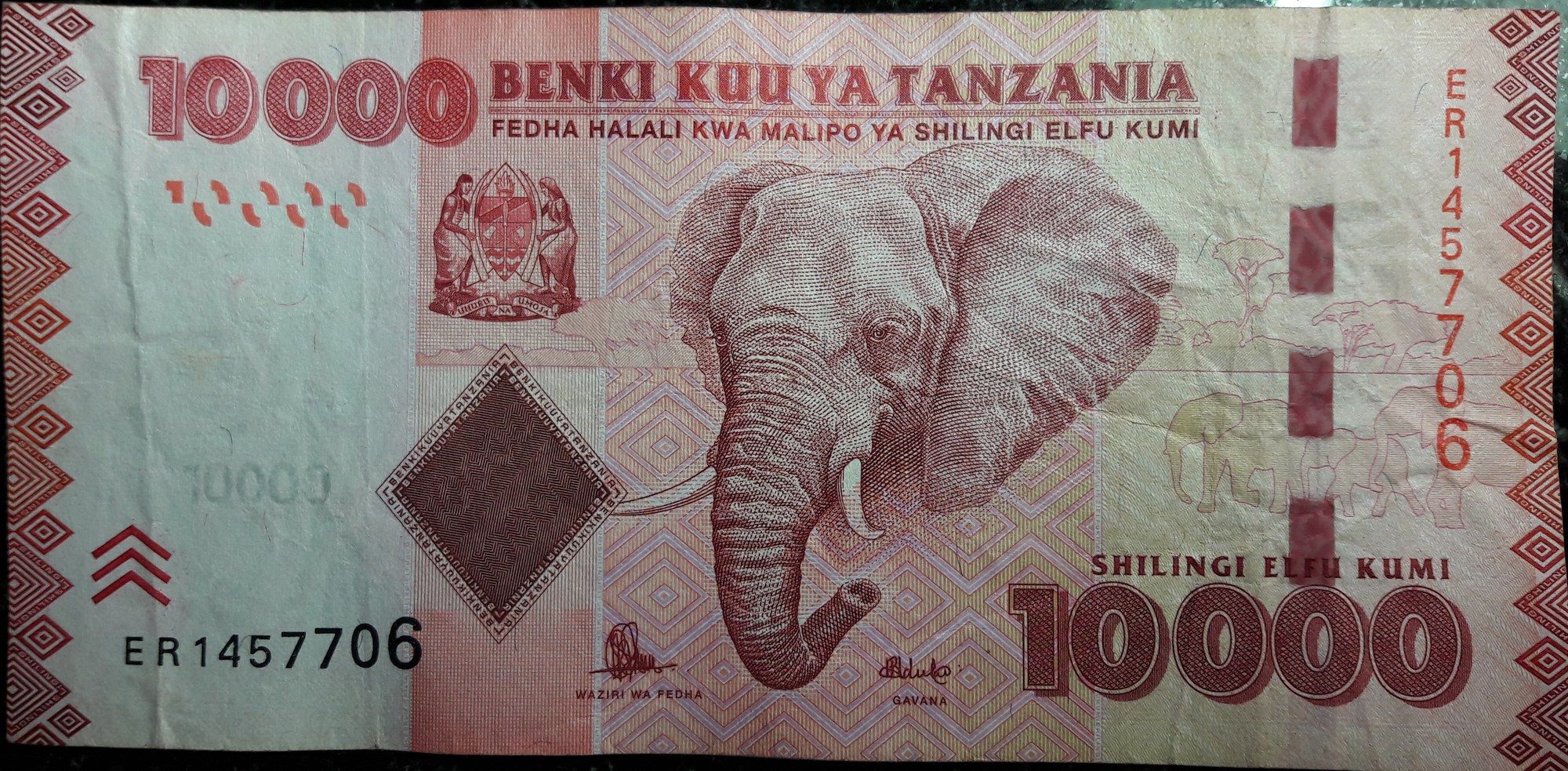 A 10,000 Tanzanian shilling banknote showing an elephant, the national coat of arms, and the Bank of Tanzania title